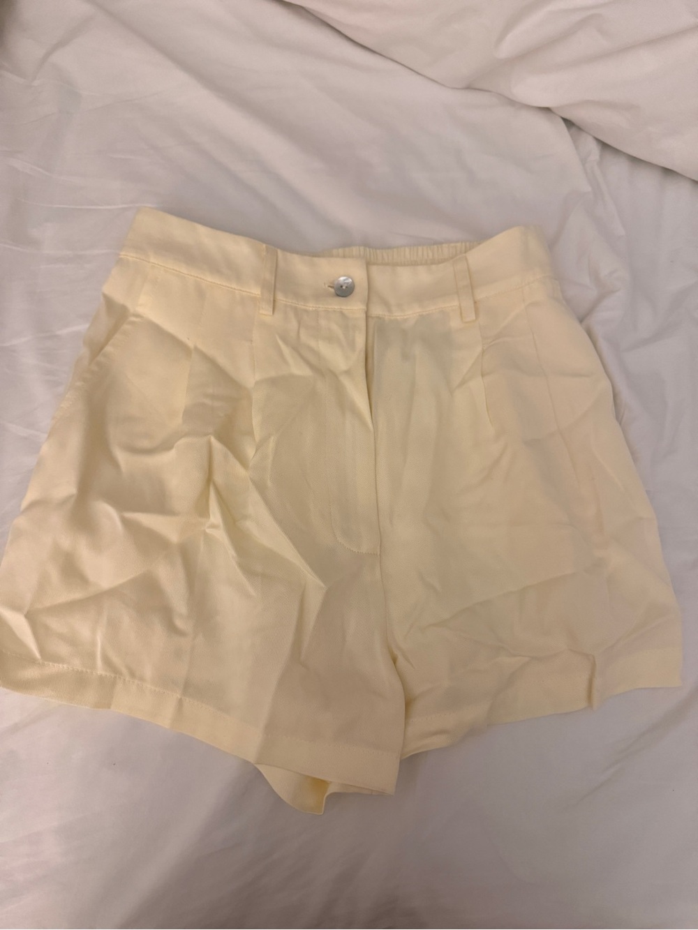 DONNI. Light Cream High-Waist Pleated Shorts
